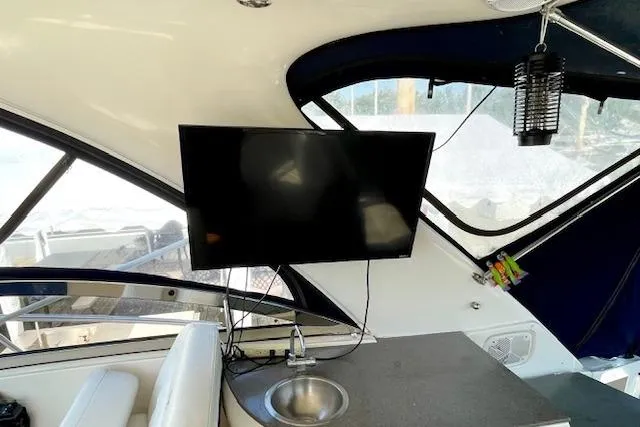 Slide: The Image of Interior of 2005 Regal Commodore 4260 yacht with TV and sink. - 10