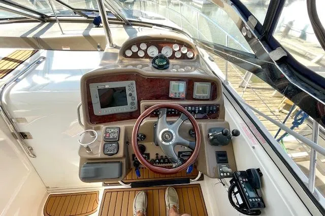 Slide: The Image of Helm of 2005 Regal Commodore 4260 yacht with navigation instruments and steering wheel. - 12