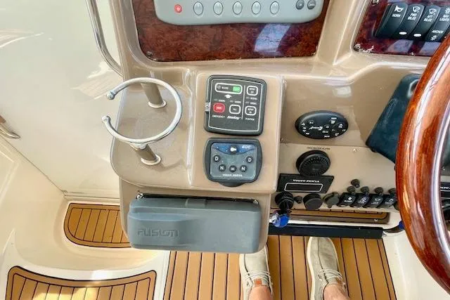 Slide: The Image of Control panel of 2005 Regal Commodore 4260 yacht with wooden flooring and electronic controls. - 13