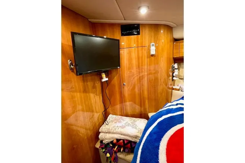 Slide: The Image of Interior of 2005 Regal Commodore 4260 yacht with TV and cozy bedding. - 39