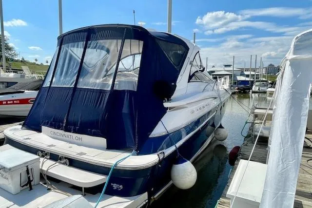Slide: The Image of 2005 Regal Commodore 4260 yacht docked in Cincinnati marina under clear blue sky. - 4