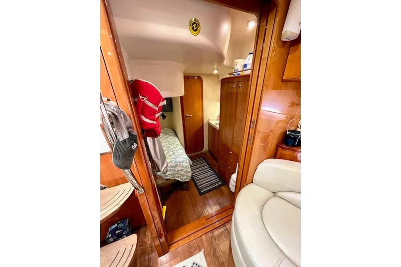 Slide: The Image of Interior of 2005 Regal Commodore 4260 yacht, featuring cozy cabin and wooden finishes. - 42