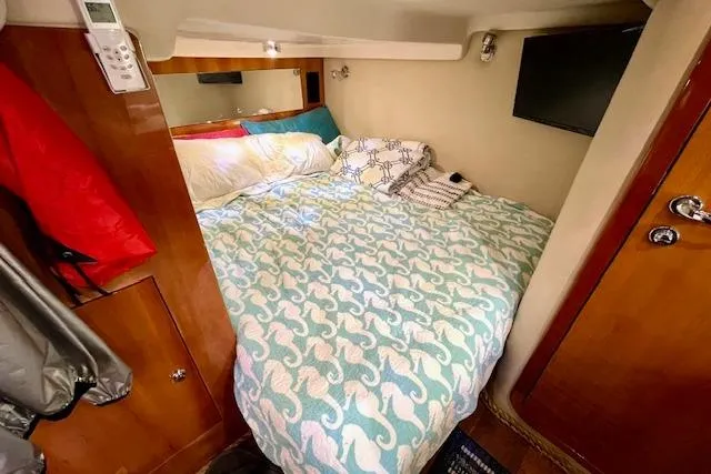 Slide: The Image of Cozy cabin interior of 2005 Regal Commodore 4260 with bed and TV. - 43