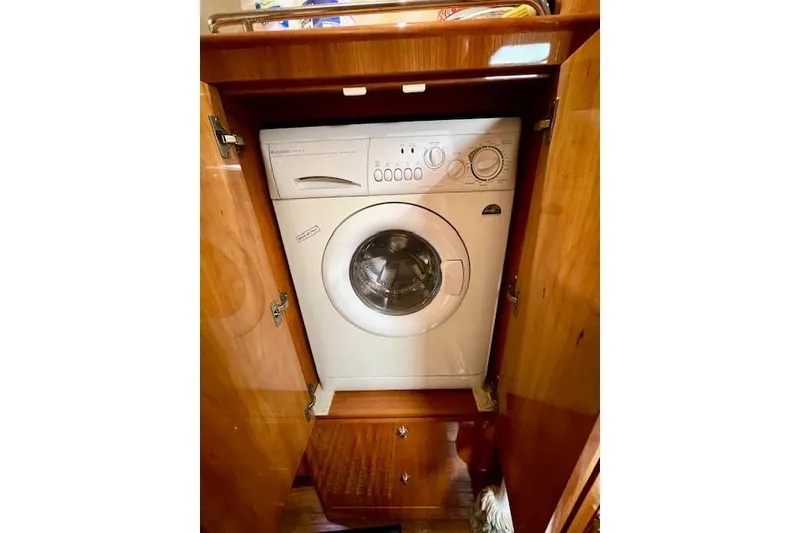 Slide: The Image of Built-in washing machine inside a 2005 Regal Commodore 4260 wooden cabinet. - 44