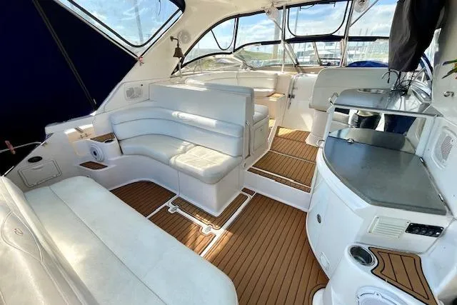Slide: The Image of Luxurious interior of 2005 Regal Commodore 4260 yacht with white seating and wood flooring. - 5