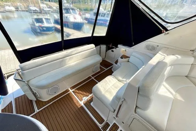 Slide: The Image of 2005 Regal Commodore 4260 yacht interior with white seating and wood flooring. - 6