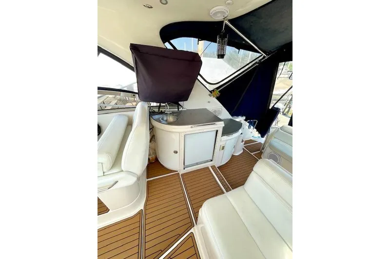 Slide: The Image of Interior of 2005 Regal Commodore 4260 yacht with white seating and wooden flooring. - 8