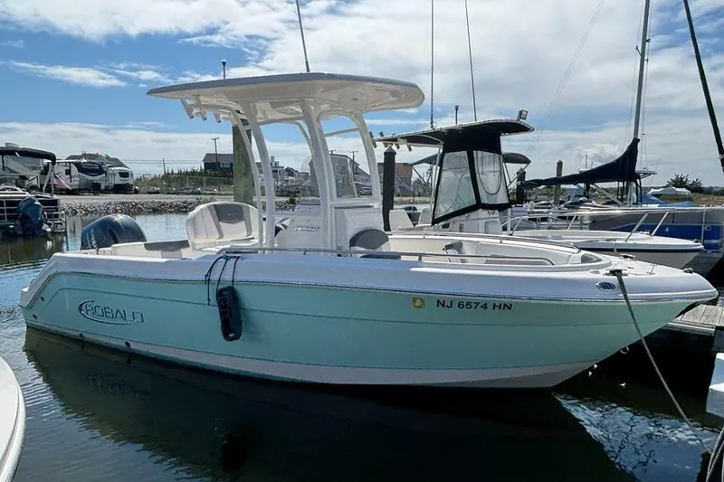 Slide: The Image of 2020 Robalo R222 Center Console boat docked in marina under blue sky. - 0