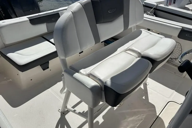 Slide: The Image of 2020 Robalo R222 Center Console boat interior with cushioned seating and console. - 12