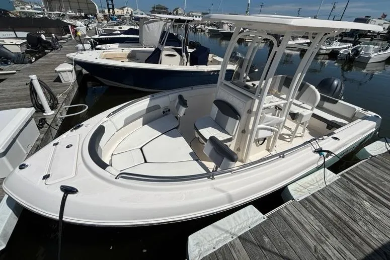 Slide: The Image of 2020 Robalo R222 Center Console boat docked at a marina. - 2