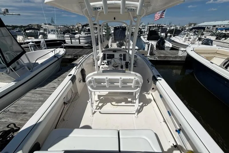 Slide: The Image of 2020 Robalo R222 Center Console boat docked at marina, featuring spacious deck and helm. - 3