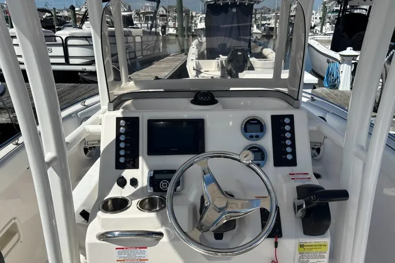 Slide: The Image of 2020 Robalo R222 Center Console boat dashboard with steering wheel and controls. - 4
