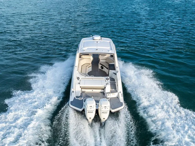 Slide: The Image of 2021 Sea Ray 350 SLX OB cruising on open water, rear view. - 10