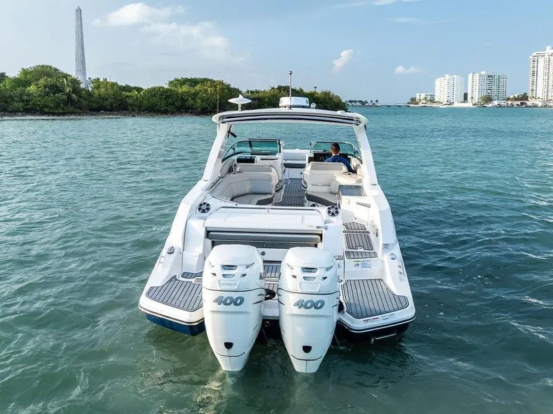 Slide: The Image of 2021 Sea Ray 350 SLX OB boat with dual engines on calm water. - 11