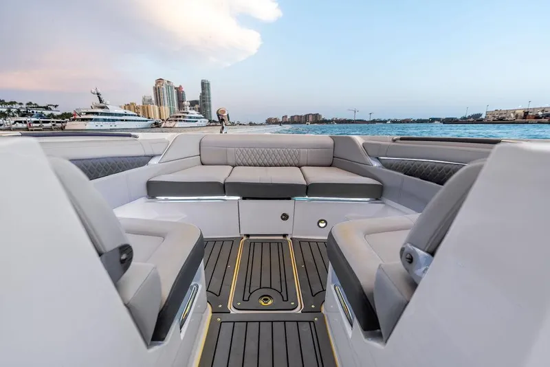Slide: The Image of 2021 Sea Ray 350 SLX OB boat interior with waterfront cityscape view. - 13