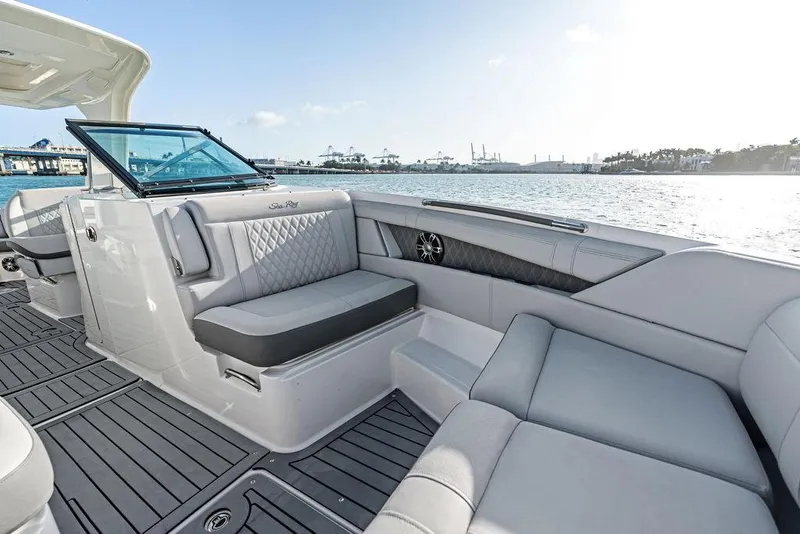 Slide: The Image of 2021 Sea Ray 350 SLX OB boat interior with luxurious seating and waterfront view. - 14