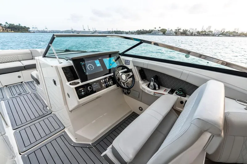 Slide: The Image of 2021 Sea Ray 350 SLX OB boat interior with modern dashboard and waterfront view. - 15