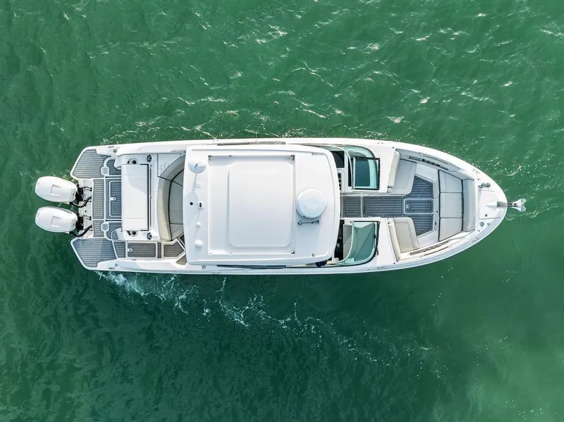 Slide: The Image of Aerial view of 2021 Sea Ray 350 SLX OB boat on green water. - 2