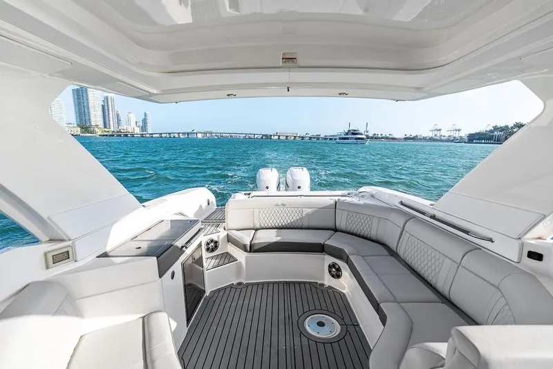 Slide: The Image of 2021 Sea Ray 350 SLX OB luxury boat interior with ocean view and modern seating. - 21