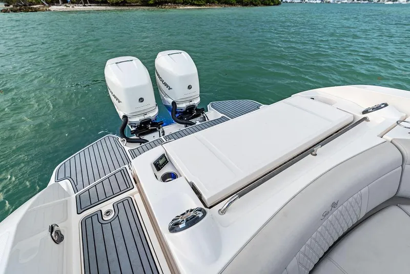 Slide: The Image of 2021 Sea Ray 350 SLX OB boat with dual outboard engines on water. - 26