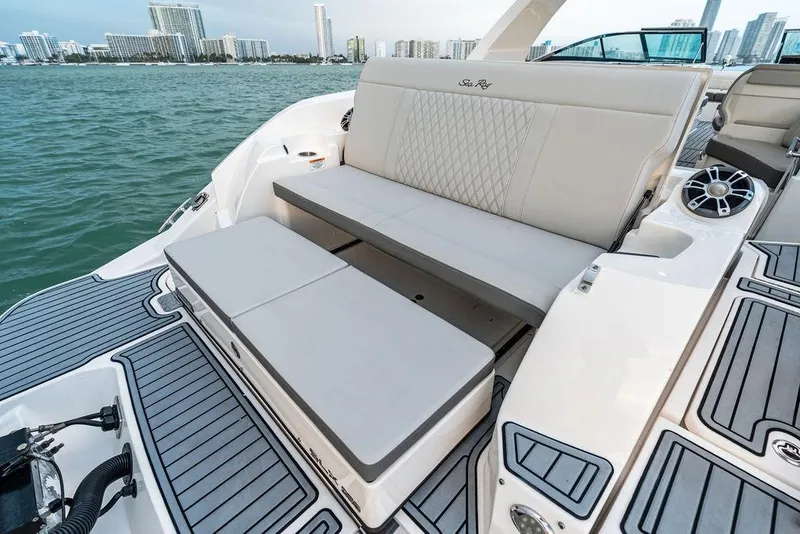 Slide: The Image of 2021 Sea Ray 350 SLX OB boat with luxurious seating and waterfront city view. - 27