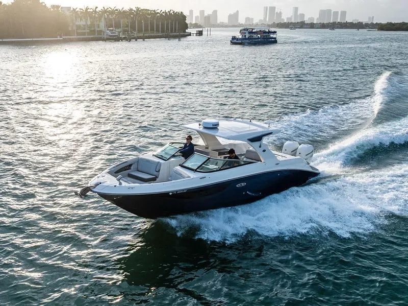 Slide: The Image of 2021 Sea Ray 350 SLX OB cruising on a scenic waterway with city skyline in the background. - 3
