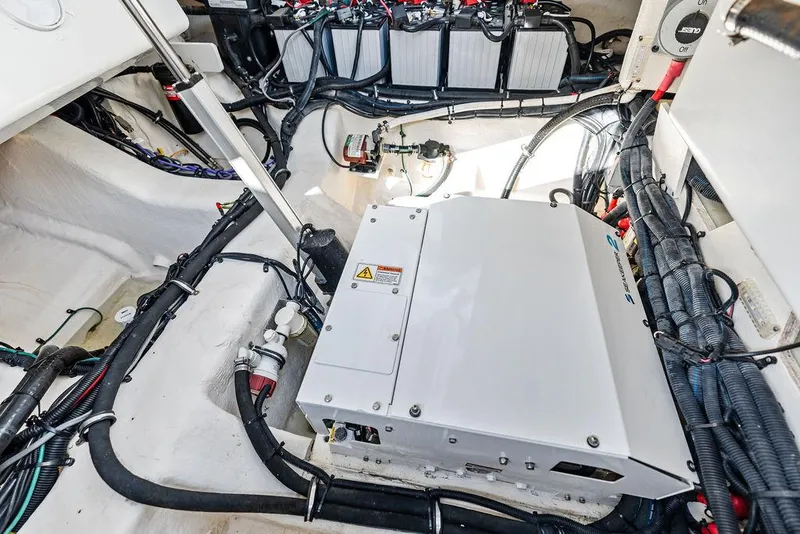 Slide: The Image of Engine compartment of 2021 Sea Ray 350 SLX OB with visible wiring and components. - 32