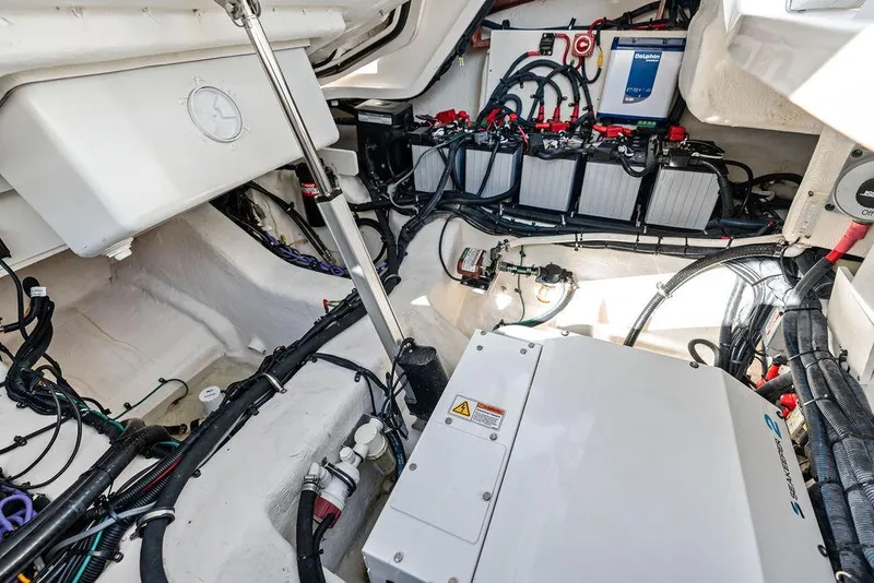 Slide: The Image of Engine compartment of 2021 Sea Ray 350 SLX OB, showcasing wiring and battery setup. - 33