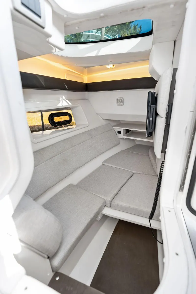 Slide: The Image of 2021 Sea Ray 350 SLX OB cabin interior with modern seating and ambient lighting. - 34