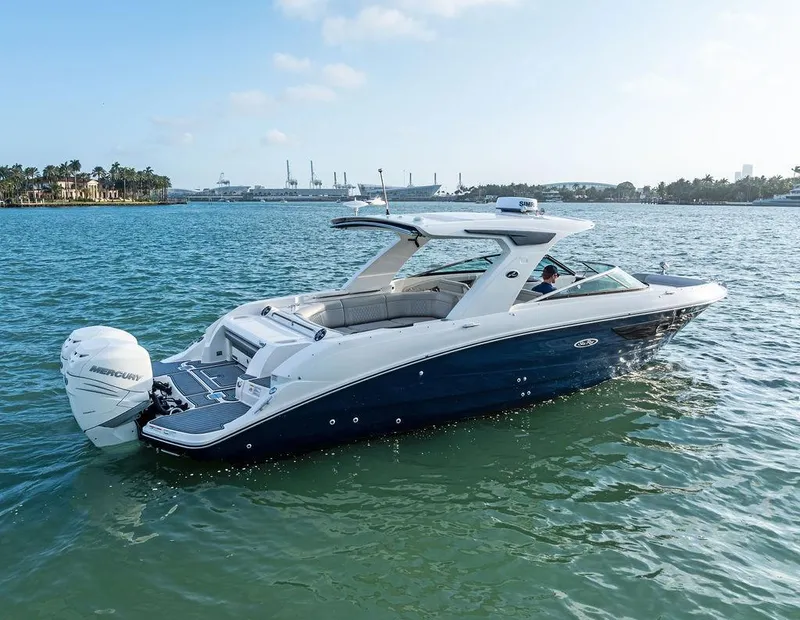 Slide: The Image of 2021 Sea Ray 350 SLX OB boat on calm water, featuring sleek design and powerful outboard engine. - 36