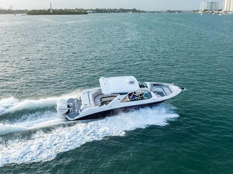 Slide: The Image of 2021 Sea Ray 350 SLX OB cruising on open water, showcasing sleek design and performance. - 8