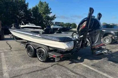 Slide: The Image of 2026 Skeeter ZXE21 boat on trailer, parked outdoors, featuring a powerful outboard motor. - 2