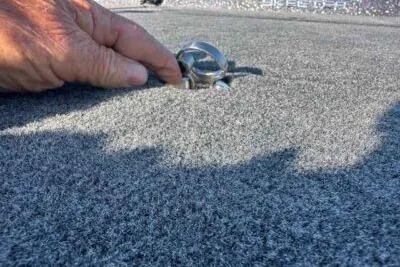 Slide: The Image of Hand adjusting cleat on 2026 Skeeter ZXE21 boat deck. - 5