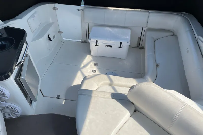 Slide: The Image of Interior of 2003 Regal Commodore 3060 boat with seating and Yeti cooler. - 13
