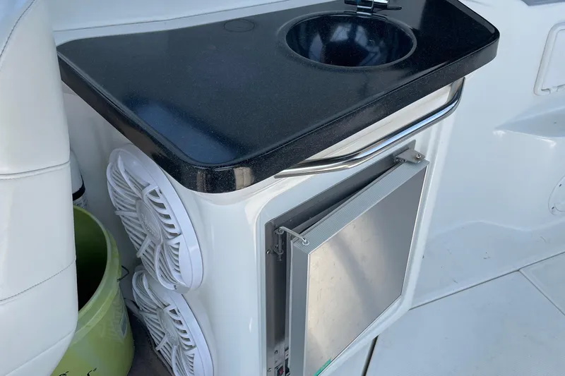 Slide: The Image of 2003 Regal Commodore 3060 boat interior with sink and storage compartment. - 15