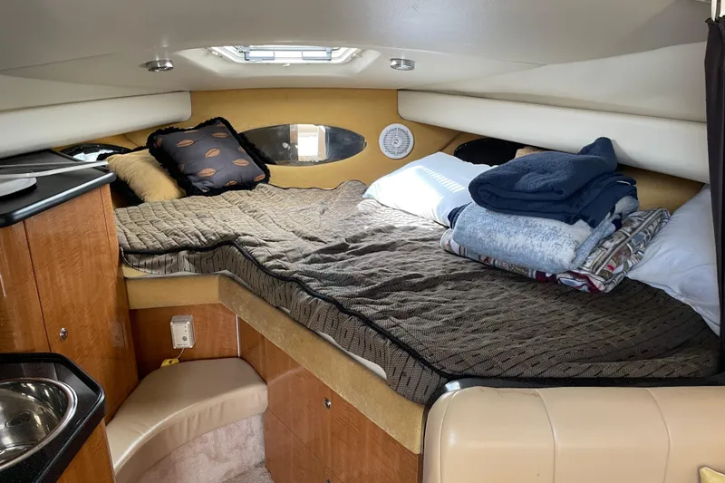 Slide: The Image of Cozy cabin interior of 2003 Regal Commodore 3060 with bed and wooden cabinetry. - 16