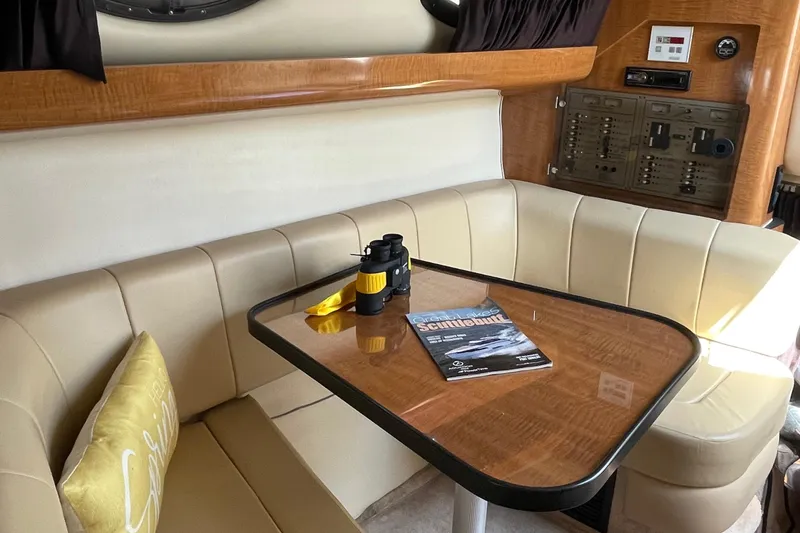 Slide: The Image of Interior of 2003 Regal Commodore 3060 with beige seating and wooden table. - 18