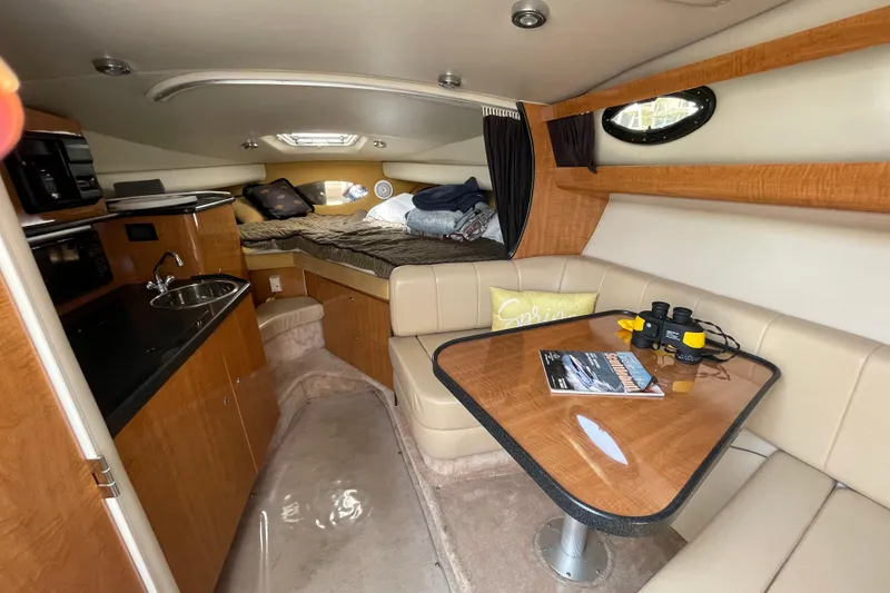 Slide: The Image of 2003 Regal Commodore 3060 cabin interior with kitchenette, seating, and bed. - 19