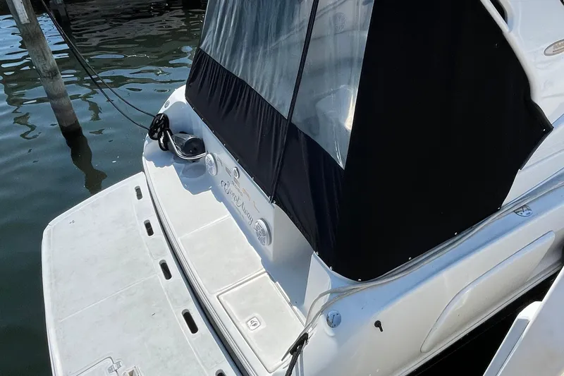 Slide: The Image of 2003 Regal Commodore 3060 boat docked with black canopy and swim platform. - 2