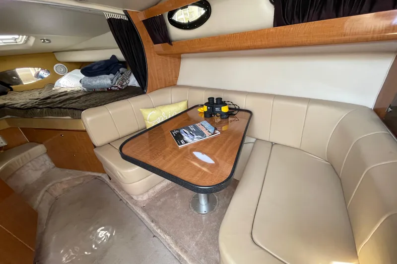 Slide: The Image of Interior of 2003 Regal Commodore 3060 boat with cozy seating and table. - 20