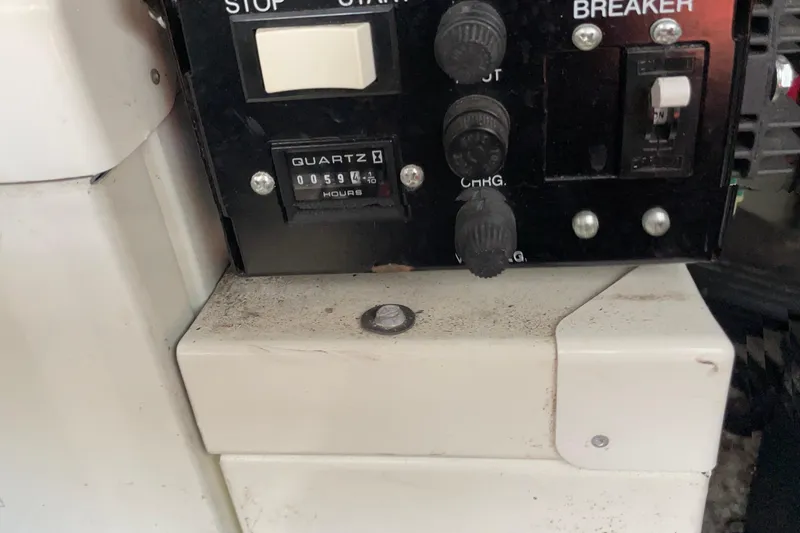 Slide: The Image of Control panel of a 2003 Regal Commodore 3060 boat with hour meter reading 594. - 27