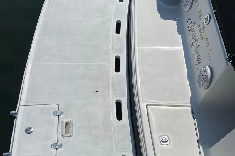 Slide: The Image of 2003 Regal Commodore 3060 boat deck with speakers and branding. - 5