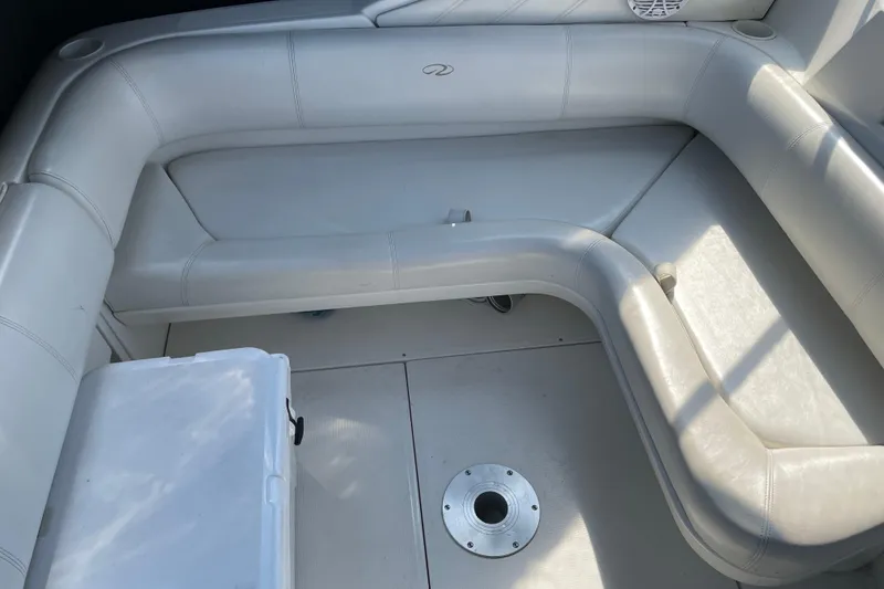 Slide: The Image of 2003 Regal Commodore 3060 boat interior with white cushioned seating. - 7