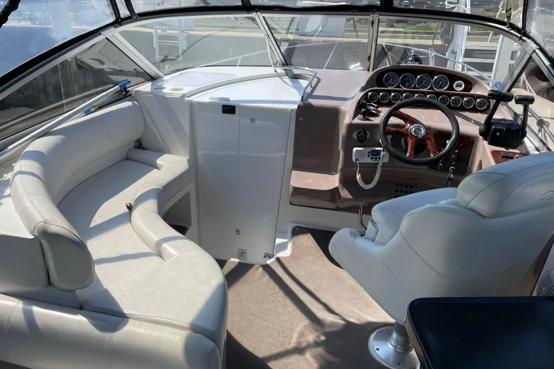 Slide: The Image of Interior of 2003 Regal Commodore 3060 boat with steering wheel and seating area. - 9