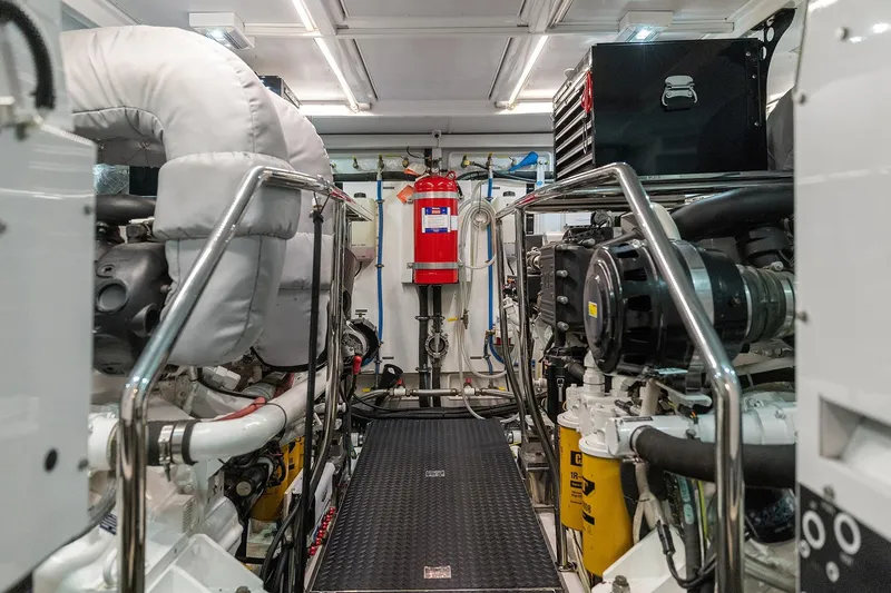 Slide: The Image of Engine room of 2014 Hampton 720 Skylounge LRC yacht, featuring advanced machinery and equipment. - 103