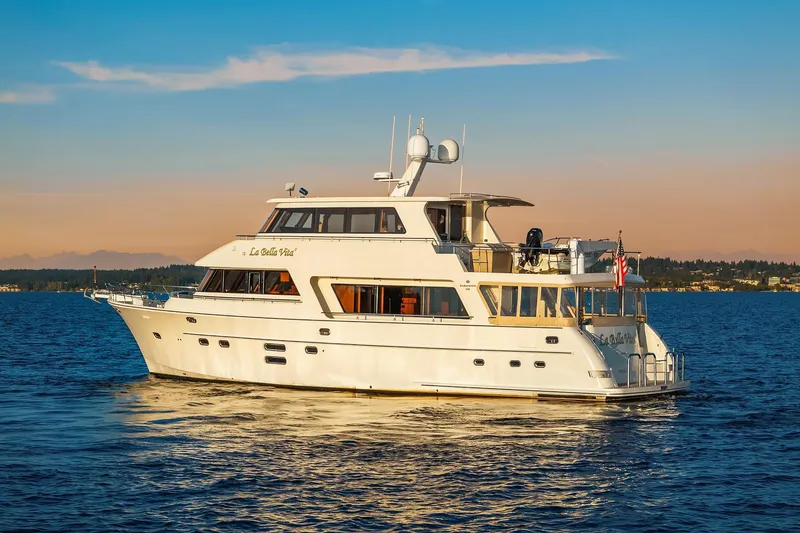 Slide: The Image of Luxurious 2014 Hampton 720 Skylounge LRC yacht cruising at sunset on serene waters. - 113