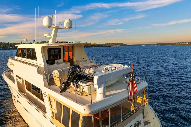 Slide: The Image of 2014 Hampton 720 Skylounge LRC yacht at sunset on tranquil water. - 114