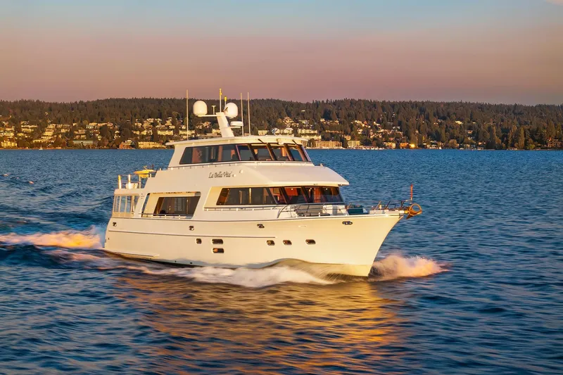 Slide: The Image of Luxurious 2014 Hampton 720 Skylounge LRC yacht cruising at sunset on serene waters. - 123