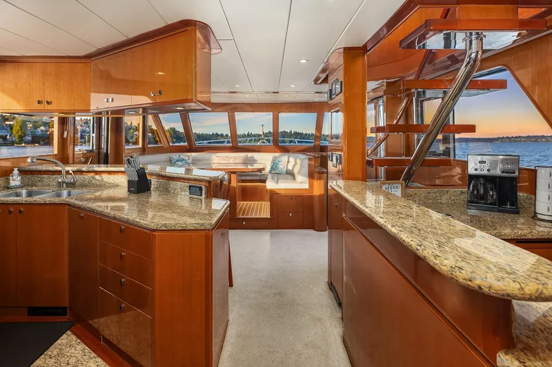 Slide: The Image of Luxurious bar area in 2014 Hampton 720 Skylounge LRC yacht with granite countertop and glassware. - 14