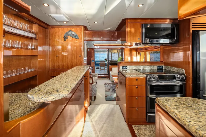 Slide: The Image of Luxurious 2014 Hampton 720 Skylounge LRC yacht interior with granite countertops and ocean view. - 15